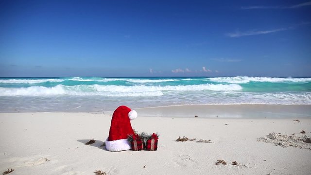Santa Hat and present box on caribbean beach
