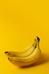 Ripe bananas on the yellow background