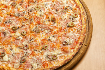 Tasty pizza on wooden board
