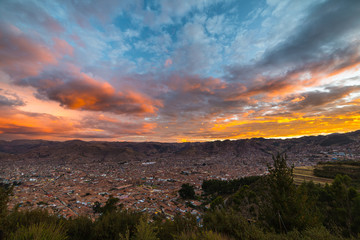 Cityscape of Cusco and cloudscape at dusk, Peru