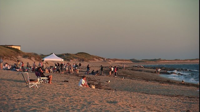 tourists on beach watching sunset, ZM out