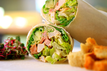healthy wrap chicken and lettuce with salad and croutons on a side shot front on close-up and cropped landscape