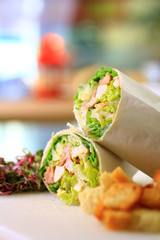 healthy wrap chicken and lettuce with salad and croutons on a side shot front on close-up and cropped portrait