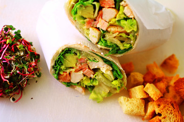 healthy wrap chicken and lettuce with salad and croutons on a side shot from above close-up and cropped landscape
