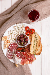 Wine snack set. Variety of cheese and meat, olives, tomatoes on