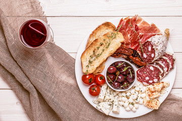Wine snack set. Variety of cheese and meat, olives, tomatoes on