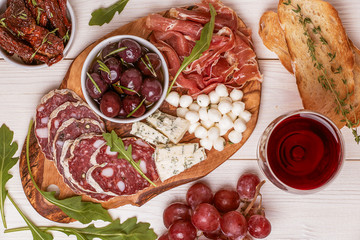 Wine snack set. Variety of cheese and meat, olives, grapes, arug