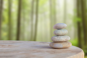 Balanced several Zen stones on blurred beautiful forest backgrou