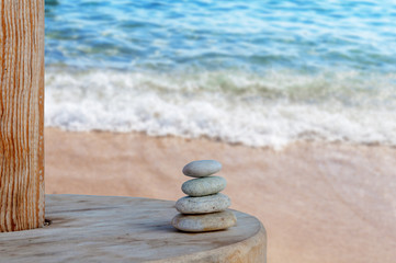 Fototapeta na wymiar Balanced several Zen stones on blurred beautiful the beach backg