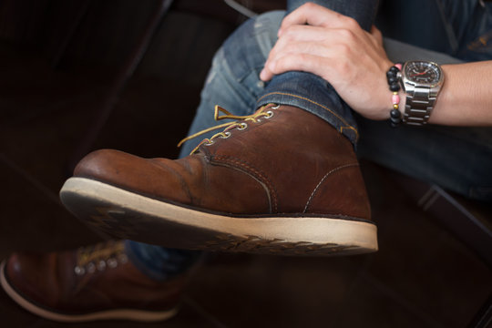 brown boot leather shoes and jean pants clothing fashion of man