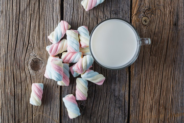 Fototapeta na wymiar Twisted colored marshmallow with milk