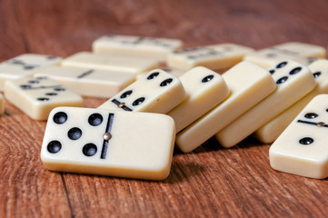 domino pieces on the brown wooden table background