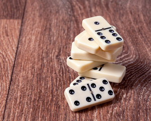 domino pieces on the brown wooden table background