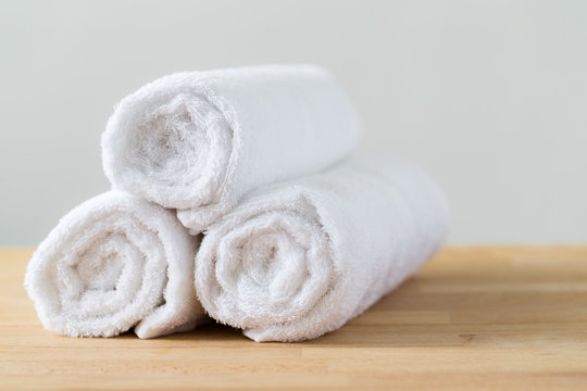 White Spa Towels Pile On Wooden Table