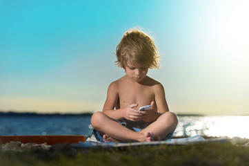 Little boy playing with smart phone