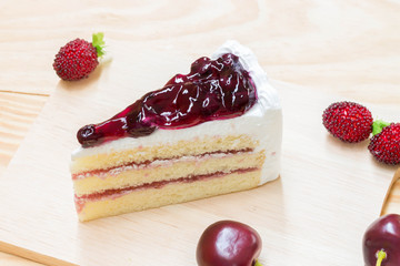 delicious sweet blueberry cheese cake on wooden with strawberry