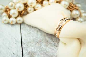 Golden wedding rings on white wood background