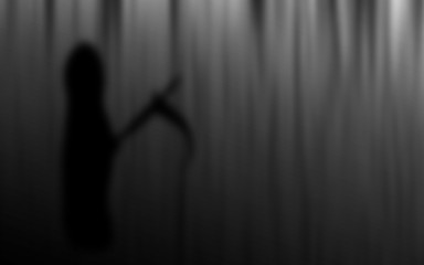 Halloween Grim Reaper silhouettes blur abstract background.
