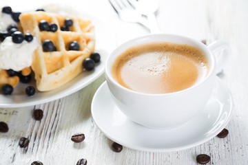 Coffee and Belgian waffles with blueberries. Breakfast