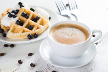 Coffee and Belgian waffles with blueberries. Breakfast