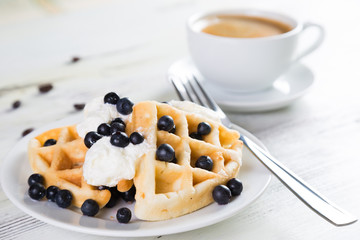 Coffee and Belgian waffles with blueberries. Breakfast