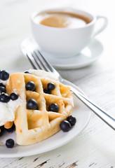 Coffee and Belgian waffles with blueberries. Breakfast