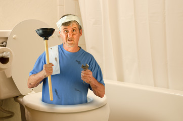 Humorous plumber inside toilet with tools and toilet paper
