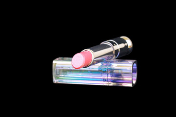 Close up red french lipstick isolated on black