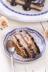 Homemade cookies cake with cream and chocolate in blue crockery
