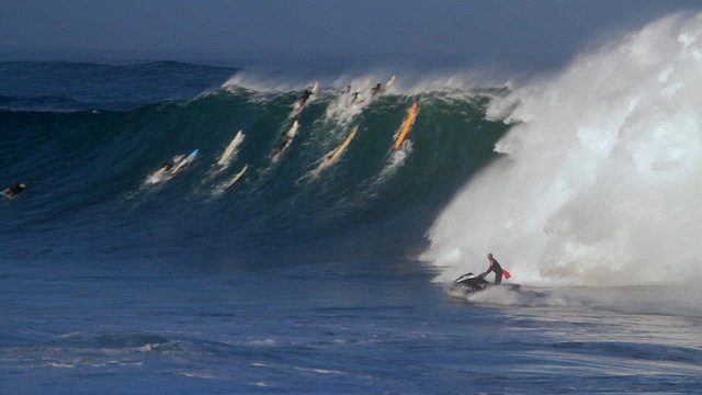 A jet skier braves huge waves in Hawaii.