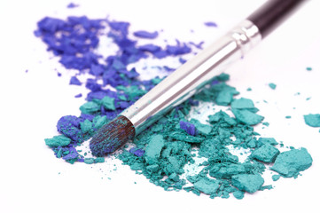 Professional make up brush on colour eyeshadows, closeup on white