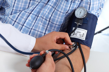 Doctor checking patient blood pressure.
