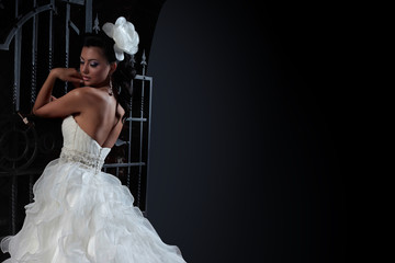 Beautiful brunette bride in black background. copy space.