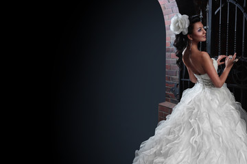 Beautiful brunette bride in black background. copy space.