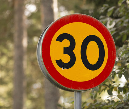 A traffic sign with thirthy as the speed limit