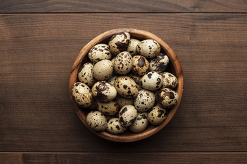 quail eggs on the brown wooden table