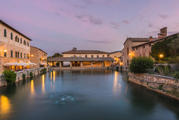View on thermal bath in the medieval Tuscan town at dusk.