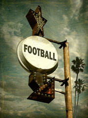 aged and worn vintage photo of football sign with palm trees