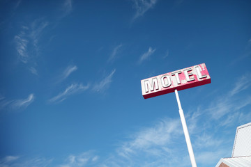 aged and worn vintage photo of neon motel sign