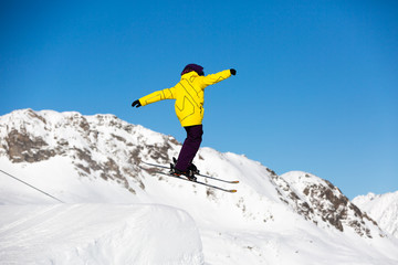 Fototapeta na wymiar Skier jumping in snow park