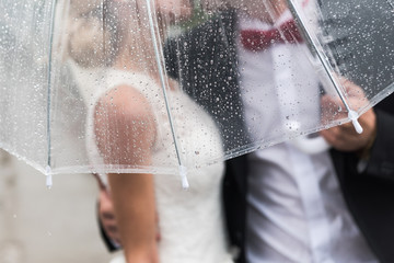 the bride and groom in the rain
