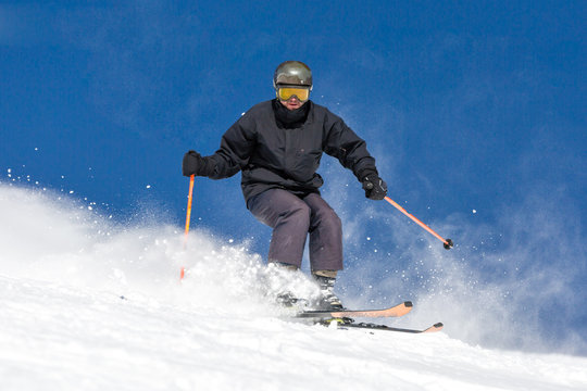 Skier skiing on ski slope