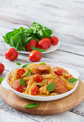 Penne pasta with tomatoes and sausage