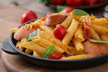 Penne pasta with tomatoes and sausage