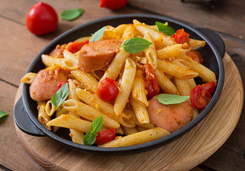 Penne pasta with tomatoes and sausage