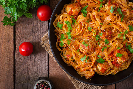 Pasta linguine with meatballs in tomato sauce. Top view