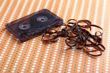 Audio tape cassette on a beige paper background