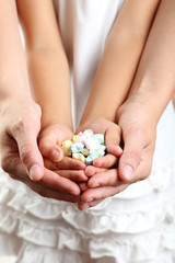 Adult hands holding kid hands