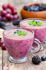 fresh healthy pulpy cocktail with purple fruits and berries