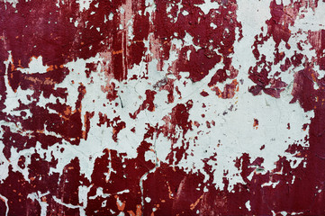 texture of red wall with paint peeling off